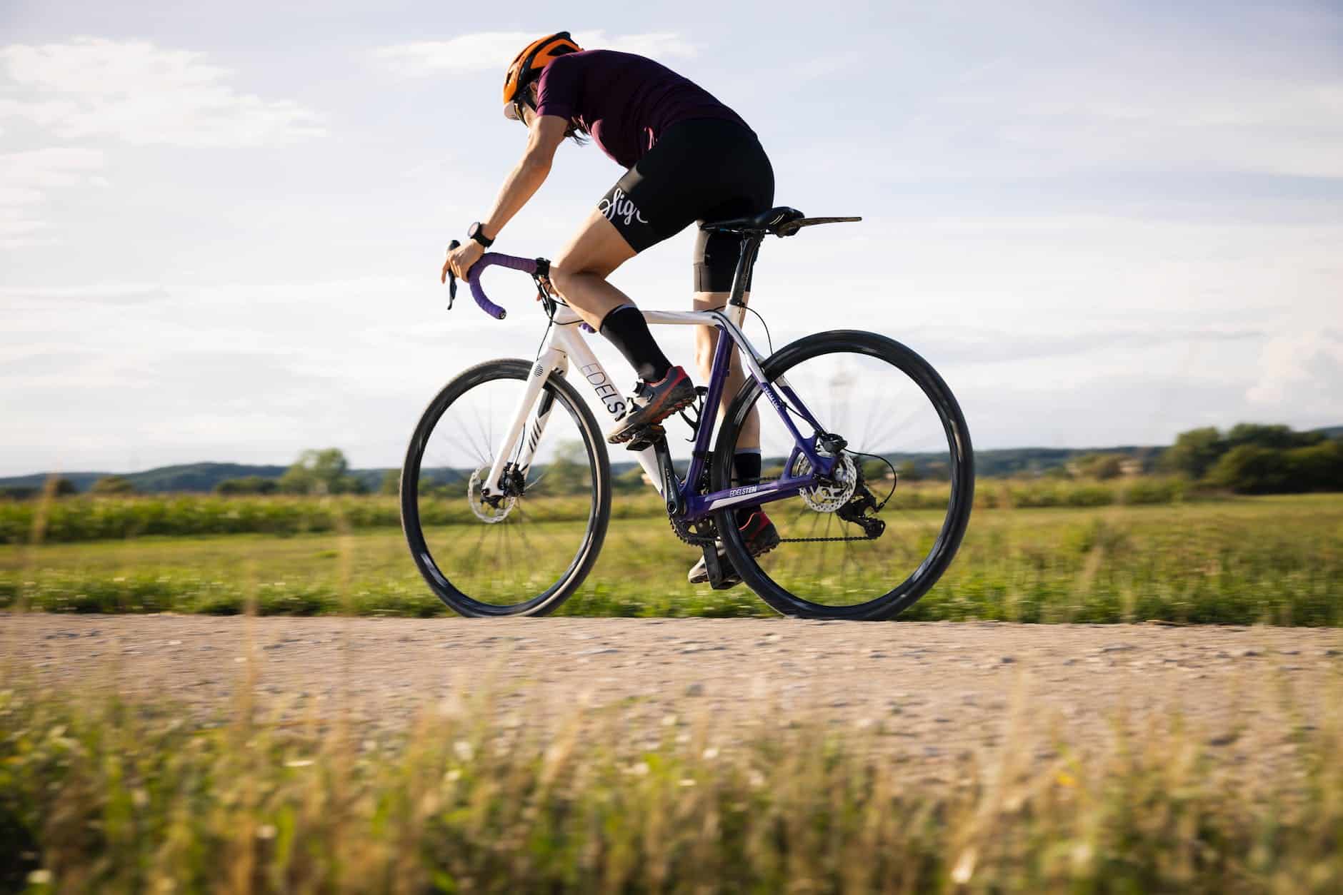side view of a person using road bike