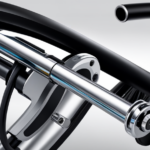 An image showcasing a close-up of a bike's handlebar, with a pair of Magura Louise brakes installed