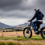 An image showcasing a thrilling scene: a rider effortlessly zooming through a picturesque countryside on an electric bike, surpassing 20mph