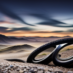 An image showcasing a close-up of a mountain bike tire rolling over loose gravel