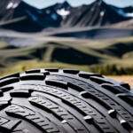 An image showcasing a close-up shot of a bike tire with thick, knobby treads, rolling effortlessly over a rugged gravel road