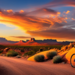 An image capturing the essence of gravel bike riding in the Southwest United States: a rugged, dusty trail winding through majestic red rock canyons, surrounded by towering saguaro cacti and bathed in the warm glow of a fiery desert sunset